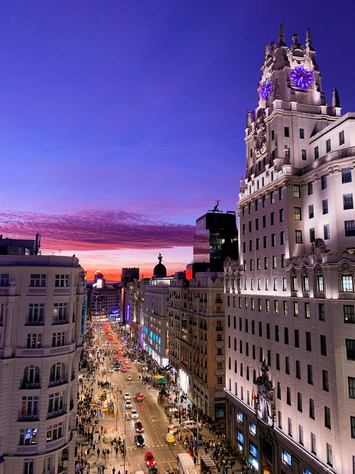 View of busy Gran Via street in central Madrid at sunset.