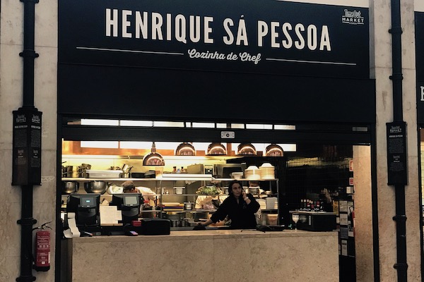 The team at Henrique Sá Pessoa's stall preparing for the lunchtime rush at Mercado da Ribeira in Lisbon.