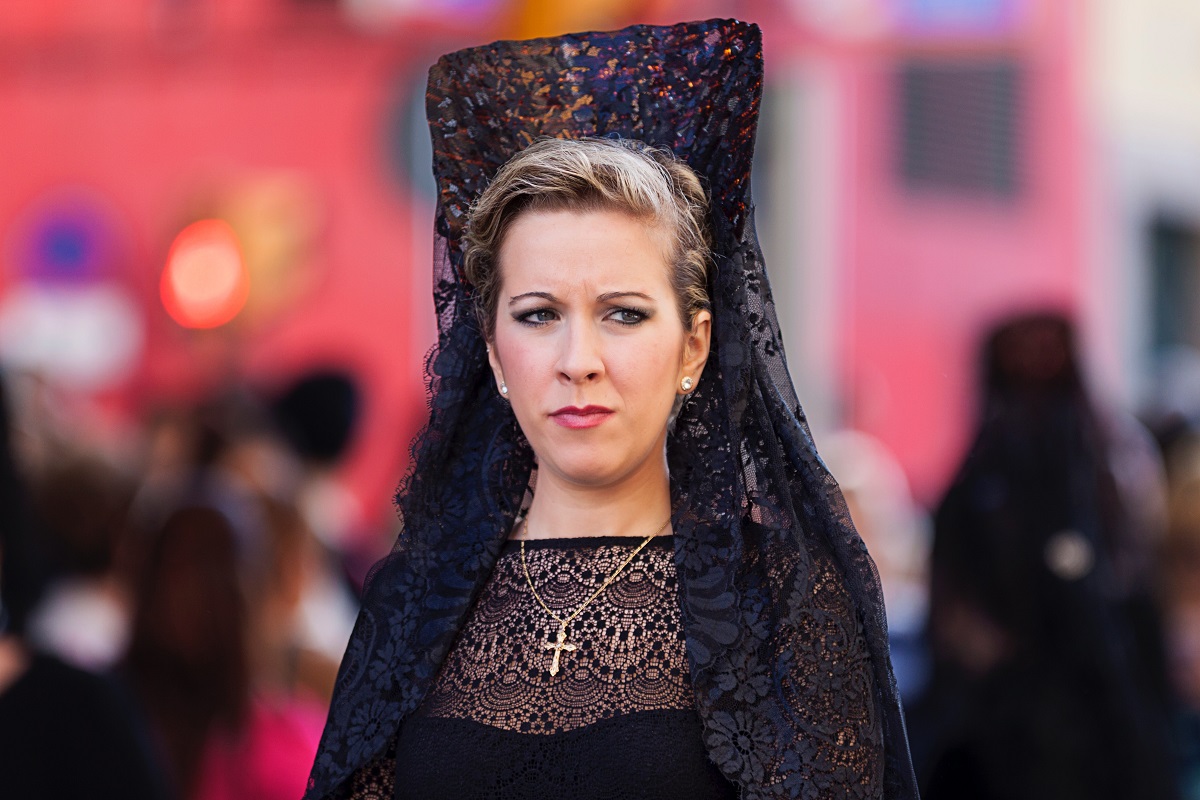 Photo of woman wearing traditional lace headpiece during Holy Week in Seville