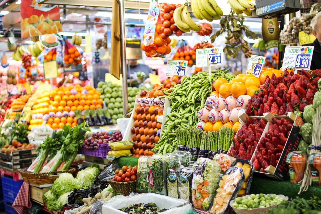 Fruits and vegetable elegantly displayed in a market in Madrid. A visit to a market is one of our tips from our Ultimate travel guide to Madrid