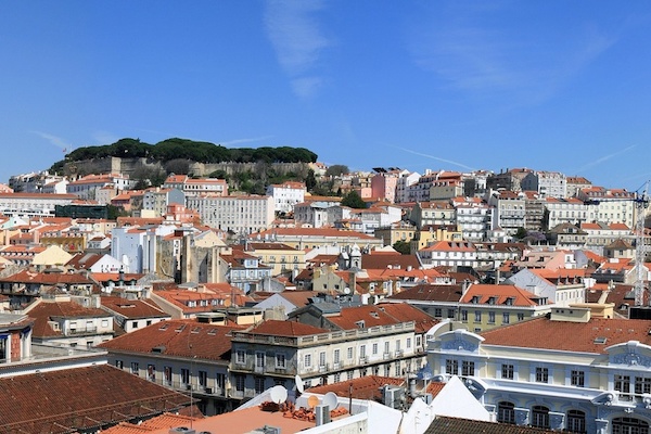 The best rooftop bars in Lisbon offer gorgeous views of the city's skyline and São Jorge Castle, pictured here.
