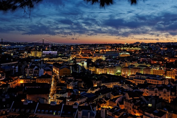 The best rooftop bars in Lisbon offer sweeping views of the city, which are just as beautiful at night when the skyline lights up.