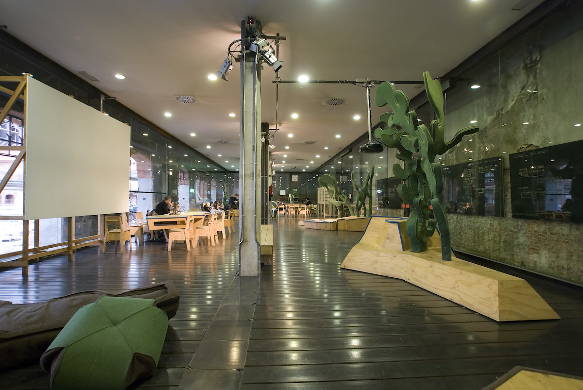 Interior of a contemporary exhibition space with a large modern sculpture in the foreground. One of the best things to do in Madrid when it rains.