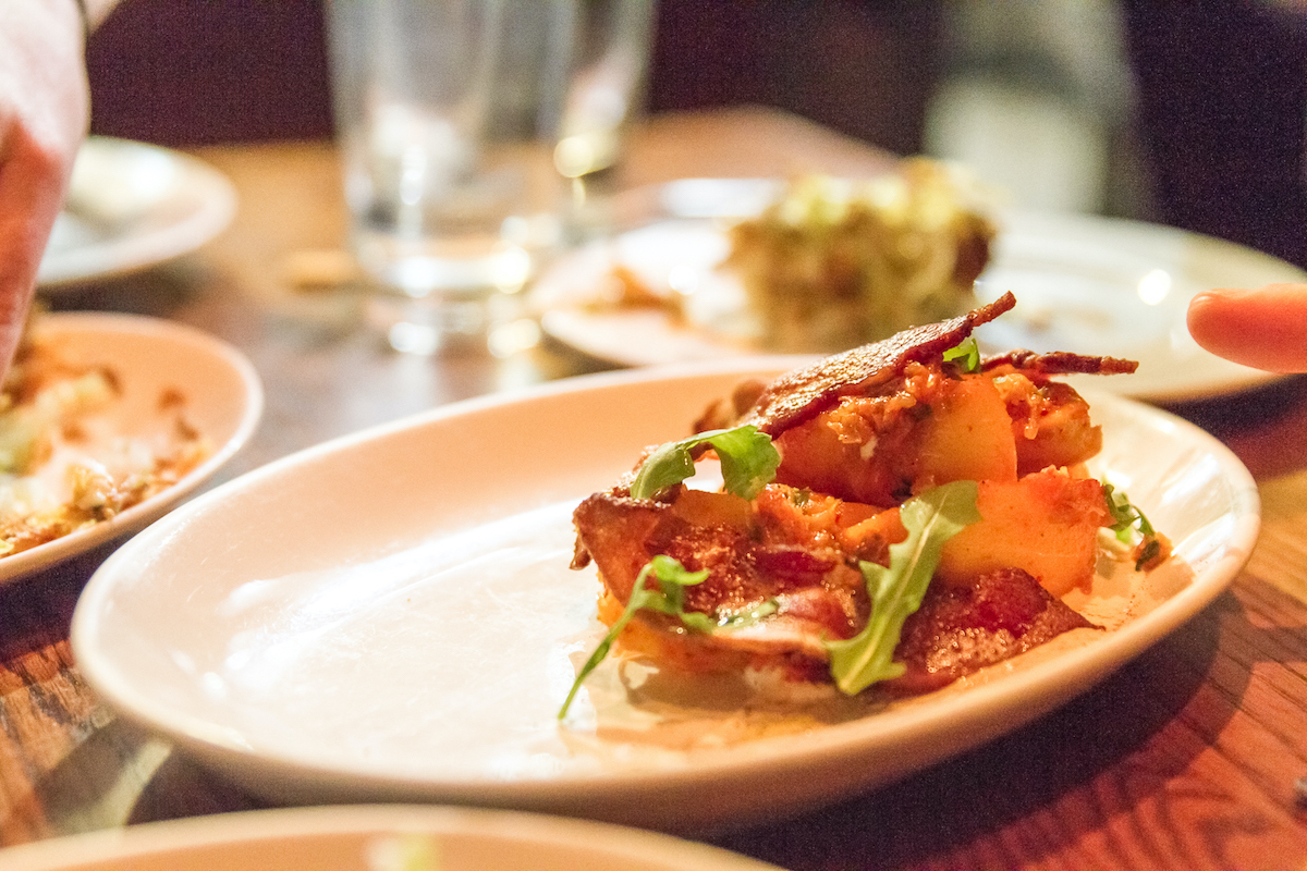 Modern presentation of an Asian-style dish on a white oval plate
