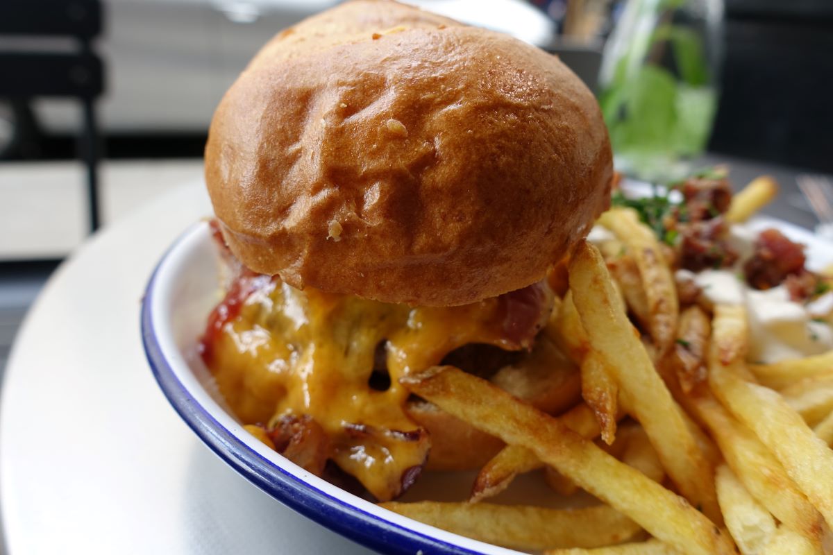 close-up of a hamburger and french fries at PNY location in Le Marais