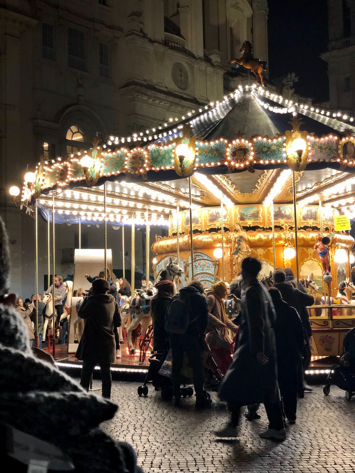merry-go-round lit up at Christmas market in Rome. 