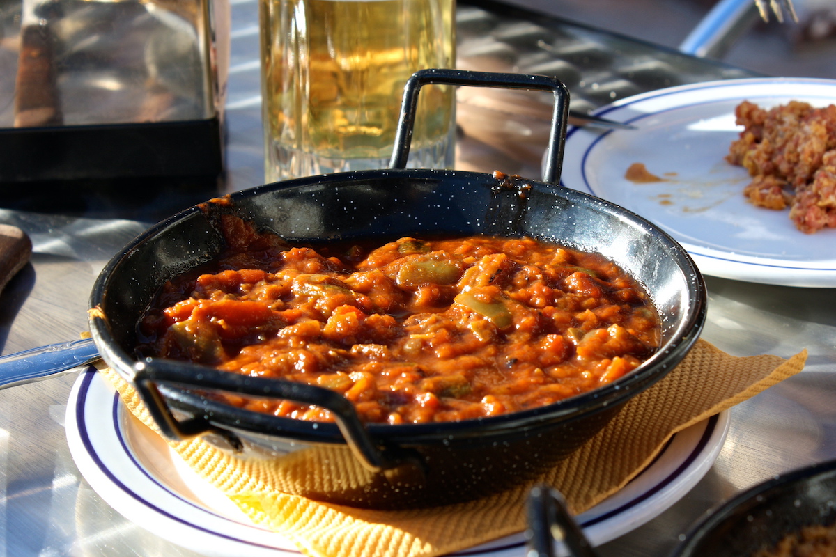 Black pot of simmered vegetable stew.