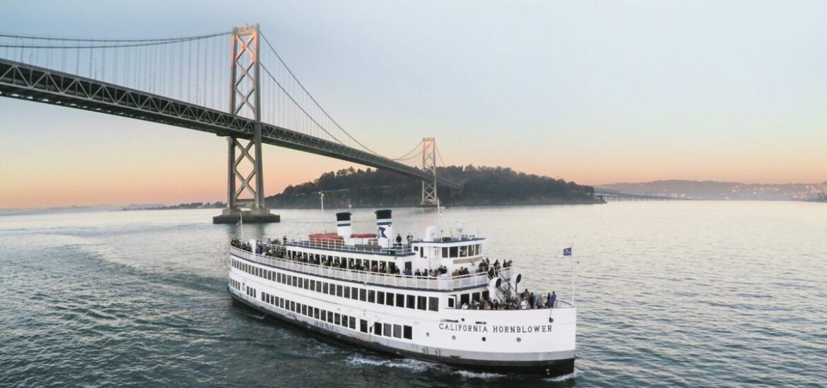 boat in front of San Francisco bridge and sunset