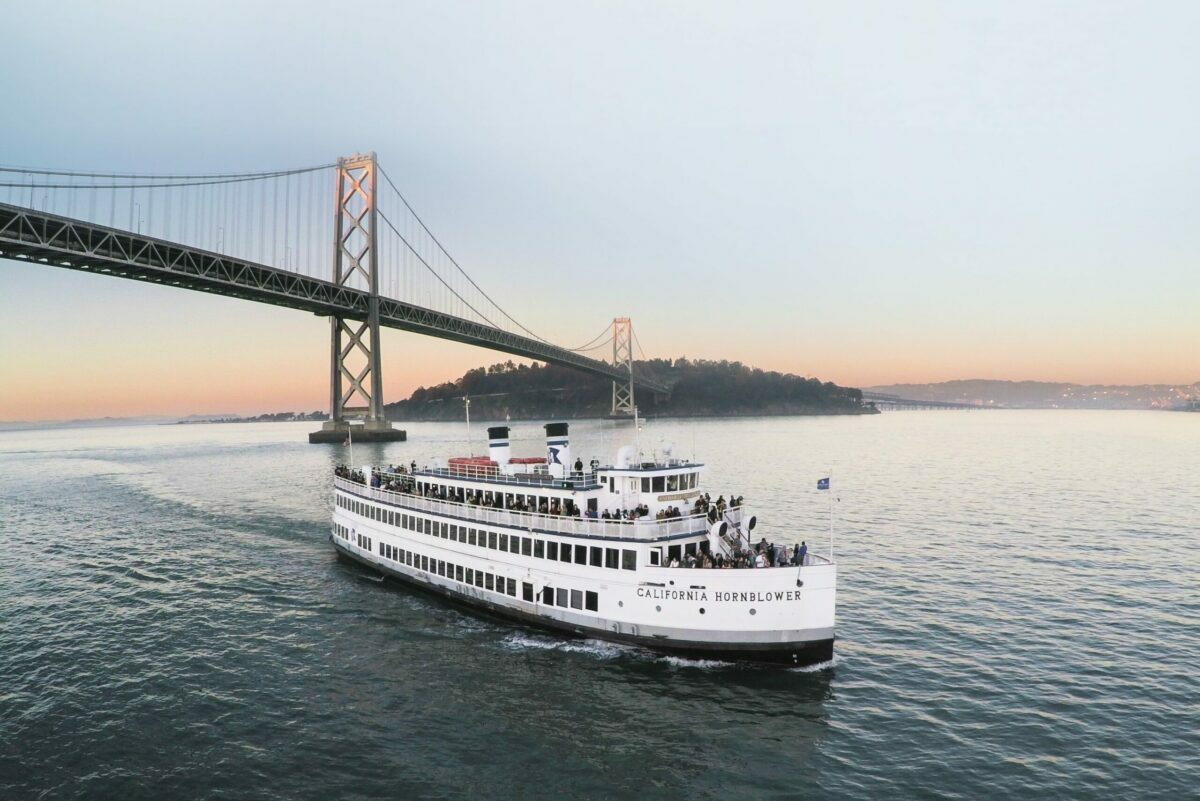 boat in front of San Francisco bridge and sunset