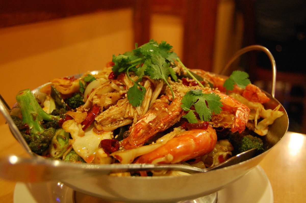 Seafood and vegetable-based Chinese dish served in a metal bowl