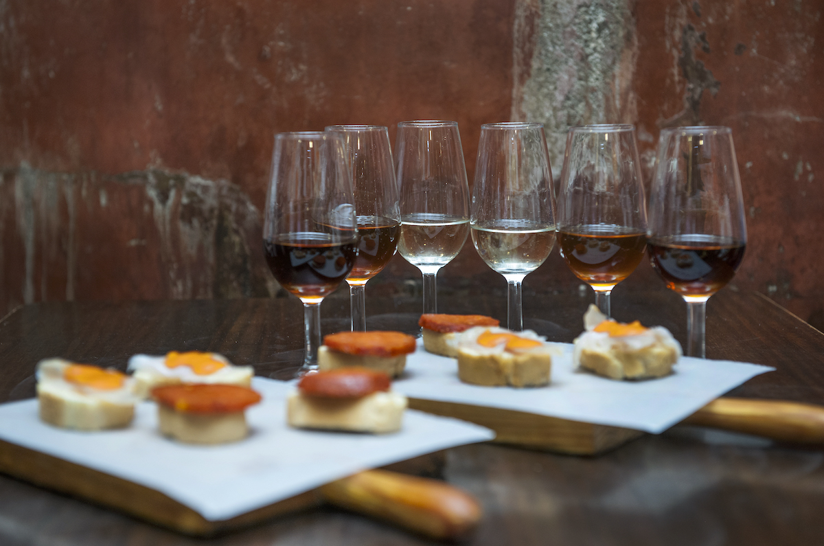 Typical foods in seville include toast with toppings and orange wine