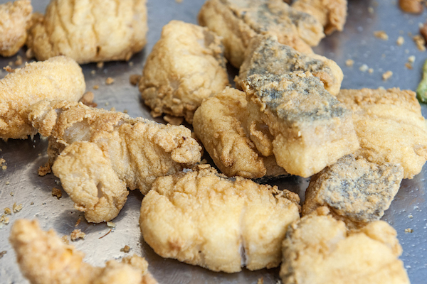 Close up of small chunks of fried fish and seafood