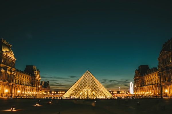 Visiting the Louvre after sundown is one of our favorite things to do in Paris alone at night!