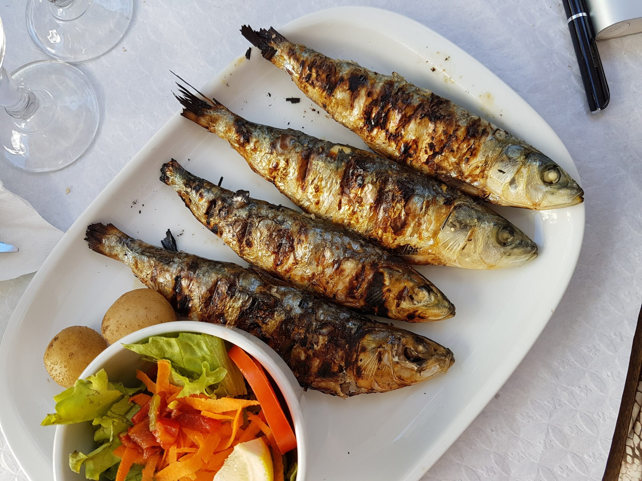 Four grilled fish on a plate 