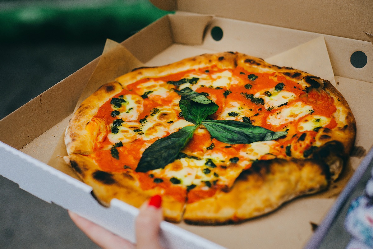 Minimalistic, fresh-baked pizza from Naples with tomato sauce, cheese, and basil
