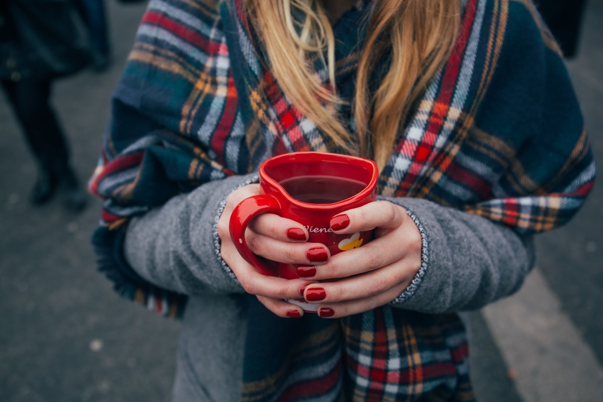 woman holding a mug with mulled wine