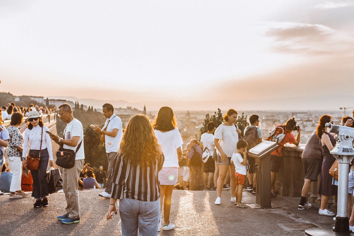 Visitors look at the Florence skyline at dusk from Piazzale Michelangelo