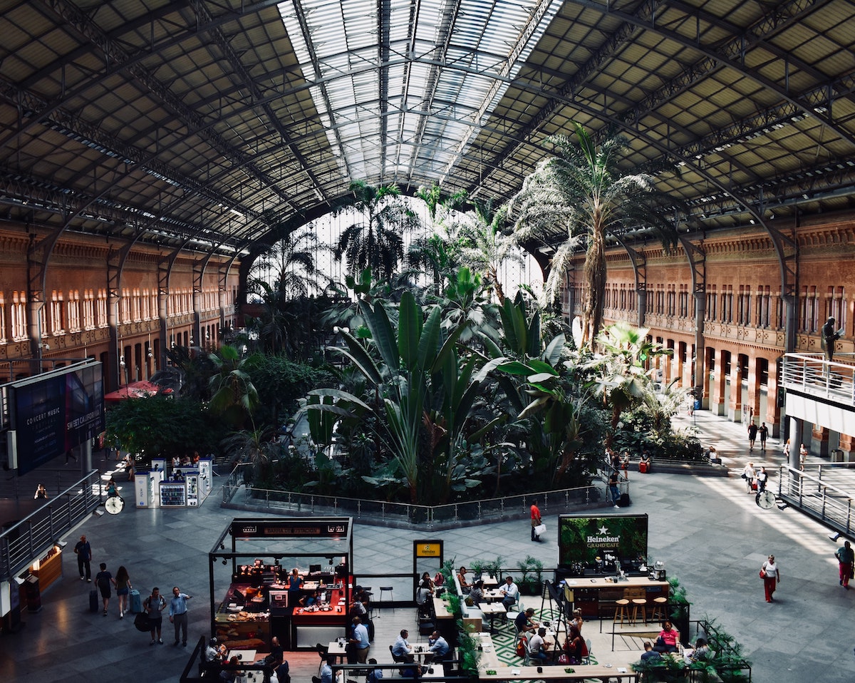 Interior of a train station with a large tropical garden
