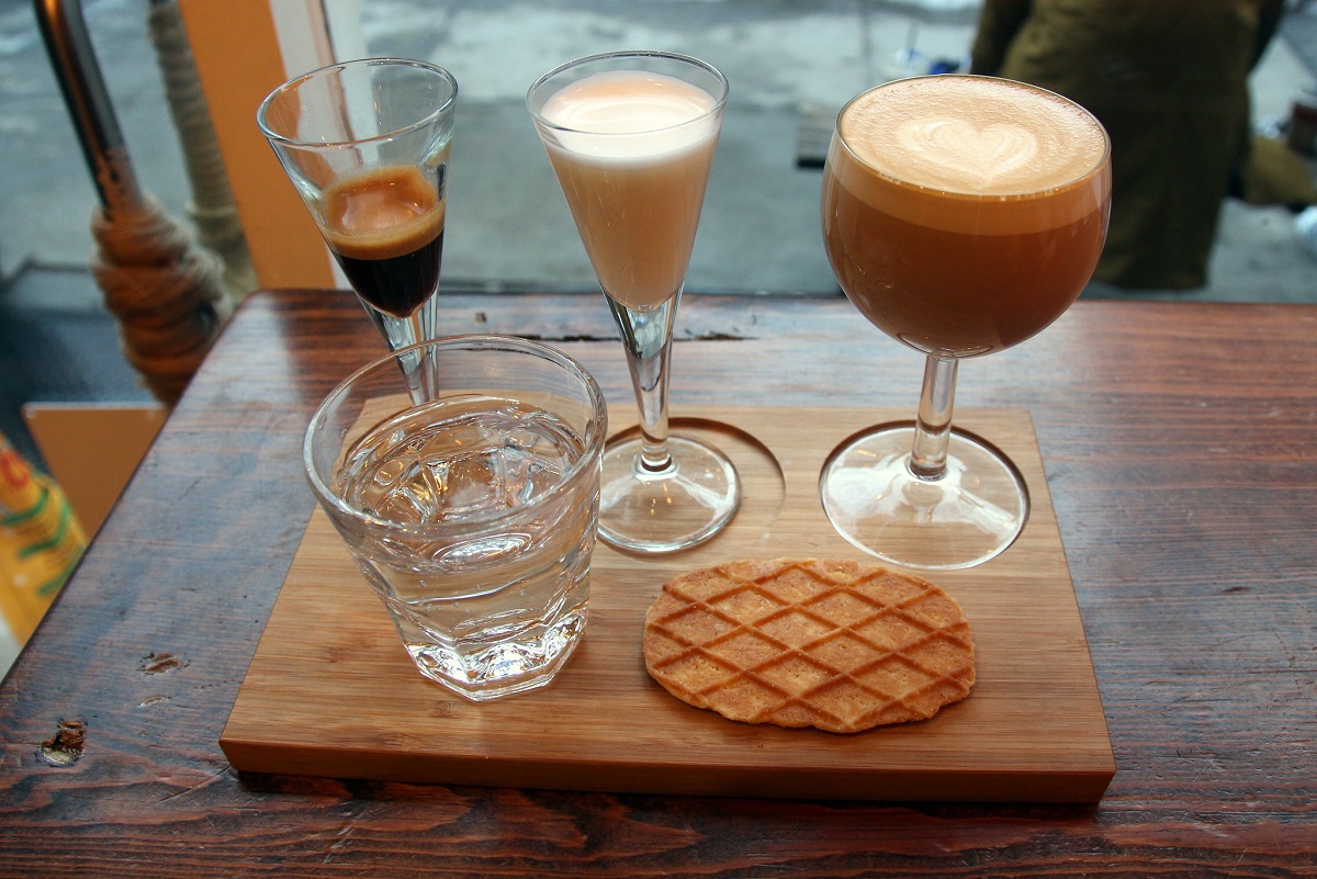 Deconstructed latte at Coffee Project NYC with water and wafer