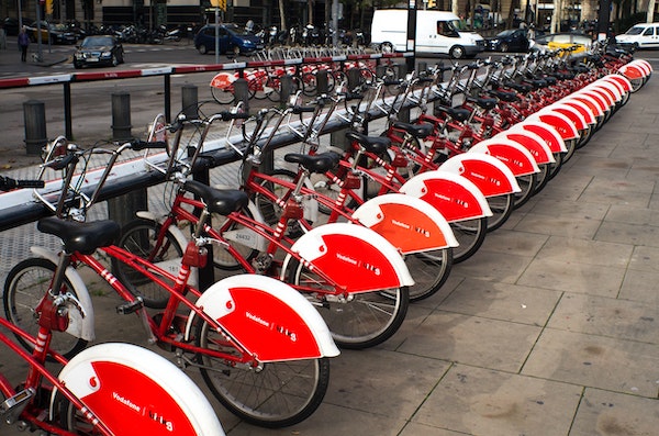 Rack of red rental bicycles