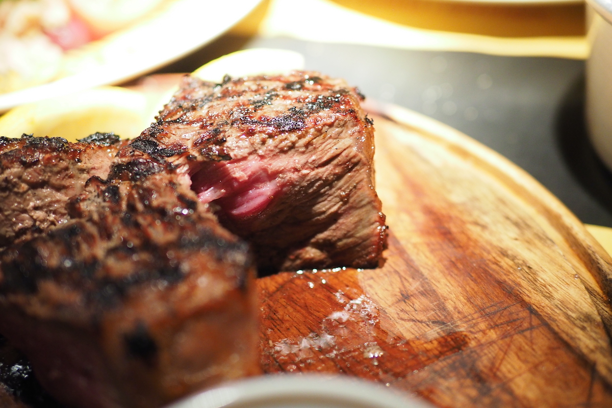 Close up of Florentine steak on a wooden plate