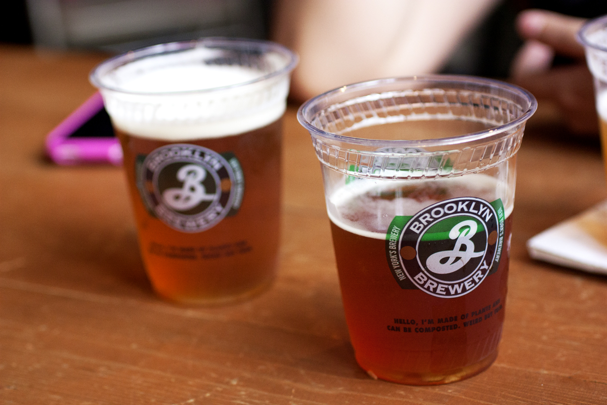 Beer from Brooklyn Brewery in two plastic cups on a wooden table