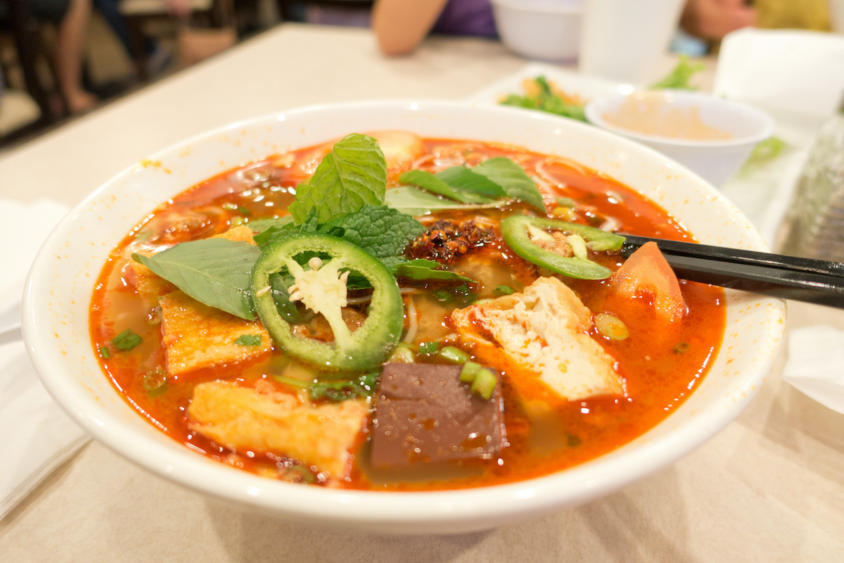 Vietnamese tomato-based soup with meat and vegetables