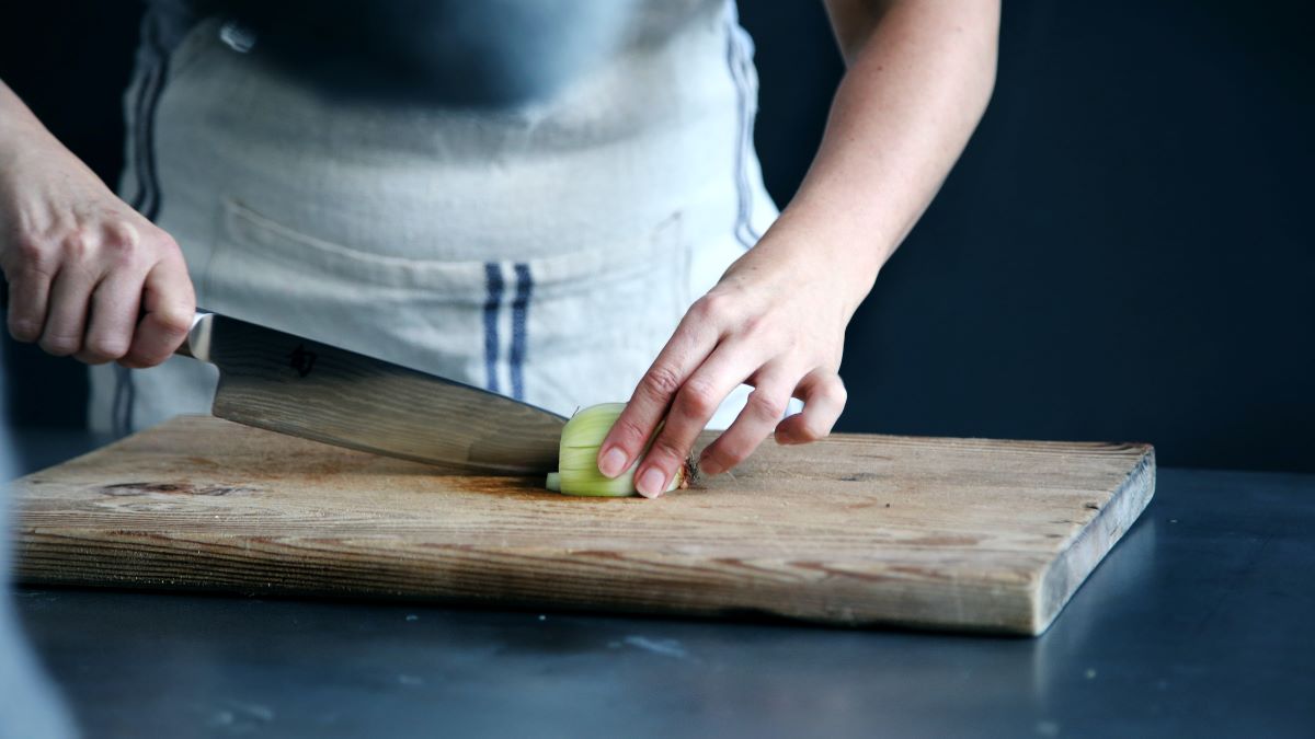 Slicing an onion on a cutting board