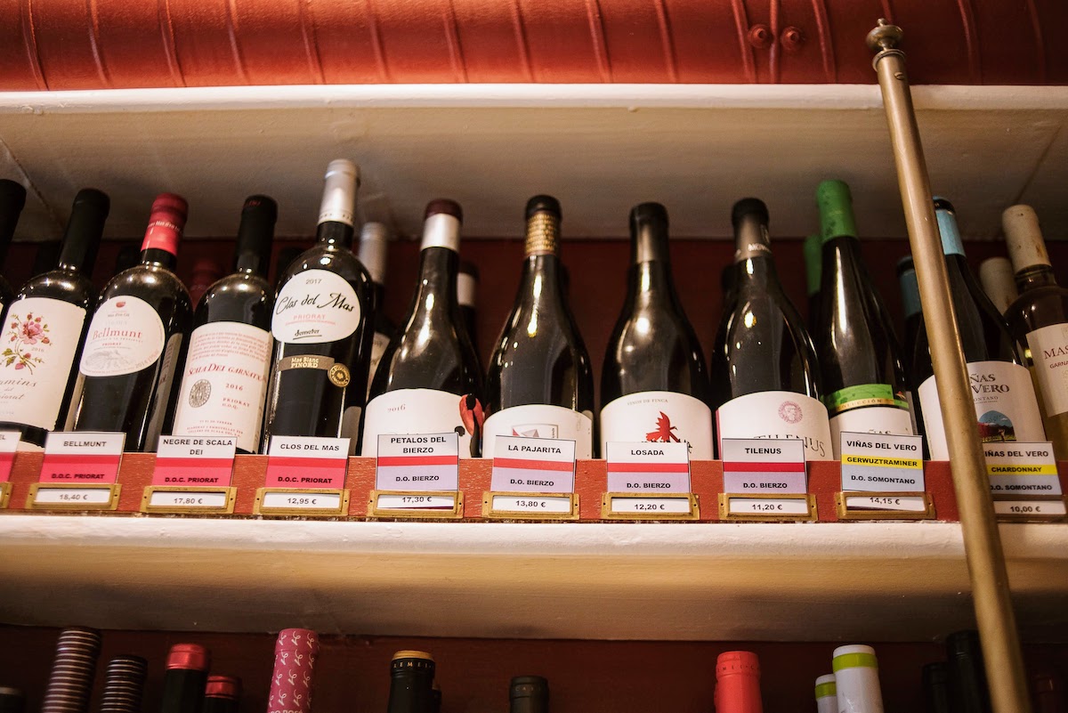 Row of wine bottles on the shelf at a shop