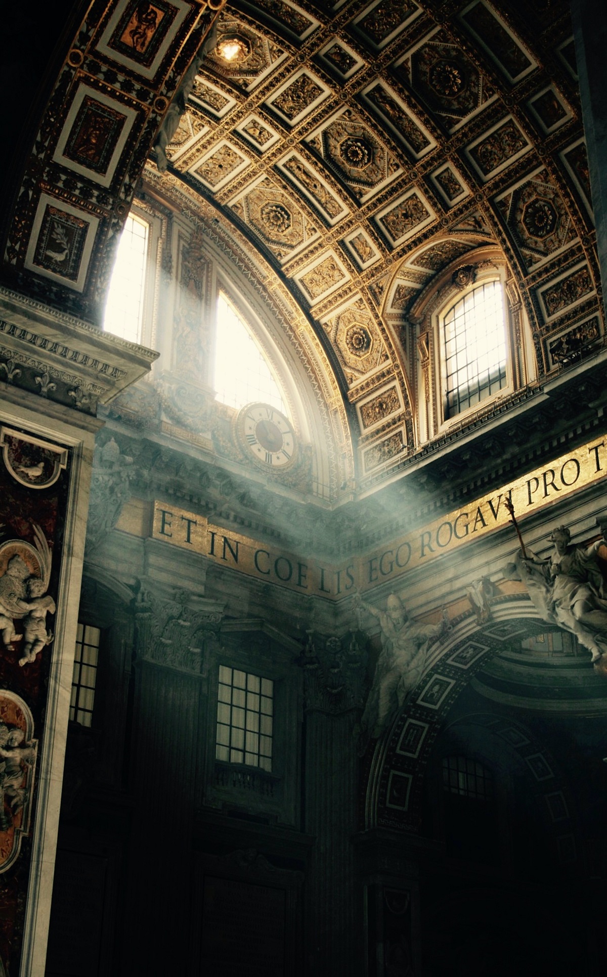 Sun pouring in through a gilded window in St. Peter's Basilica in the Vatican