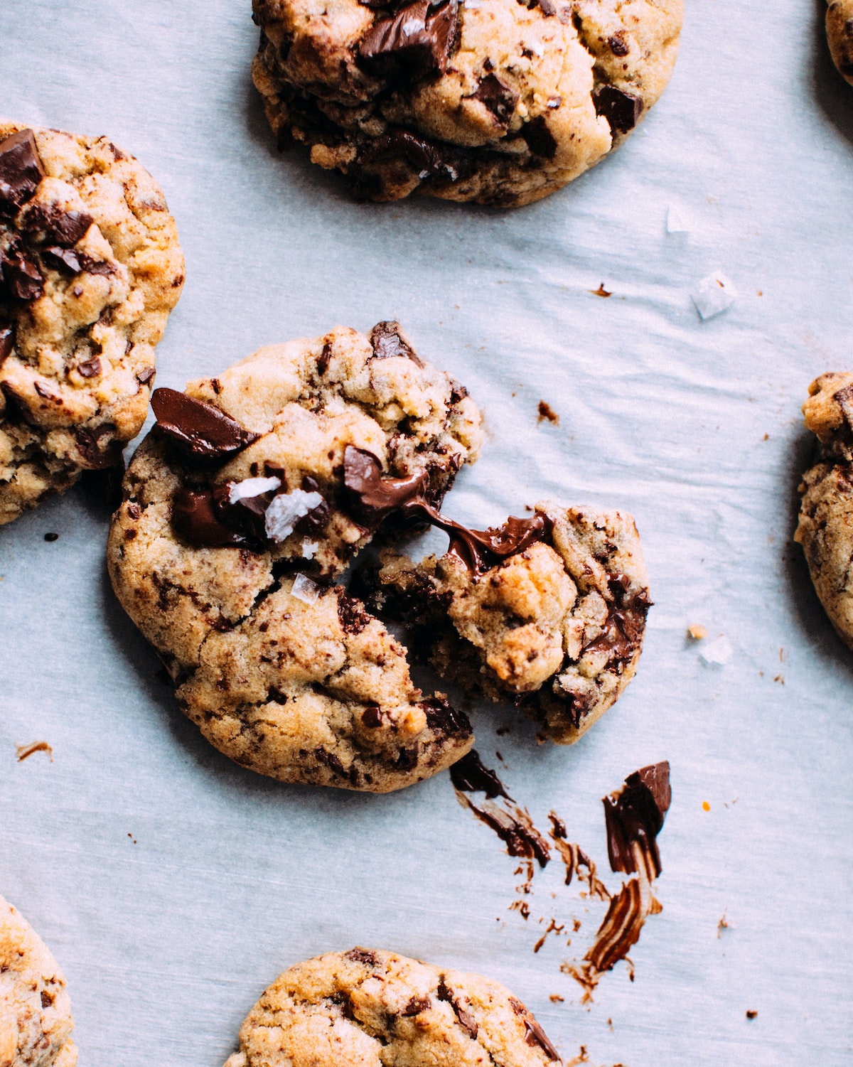 Overhead shot of chocolate chip cookies on white parchment paper