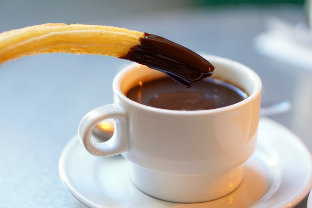 Churros and chocolate for a late afternoon snack is one of our tips for how to eat like a local in Madrid.