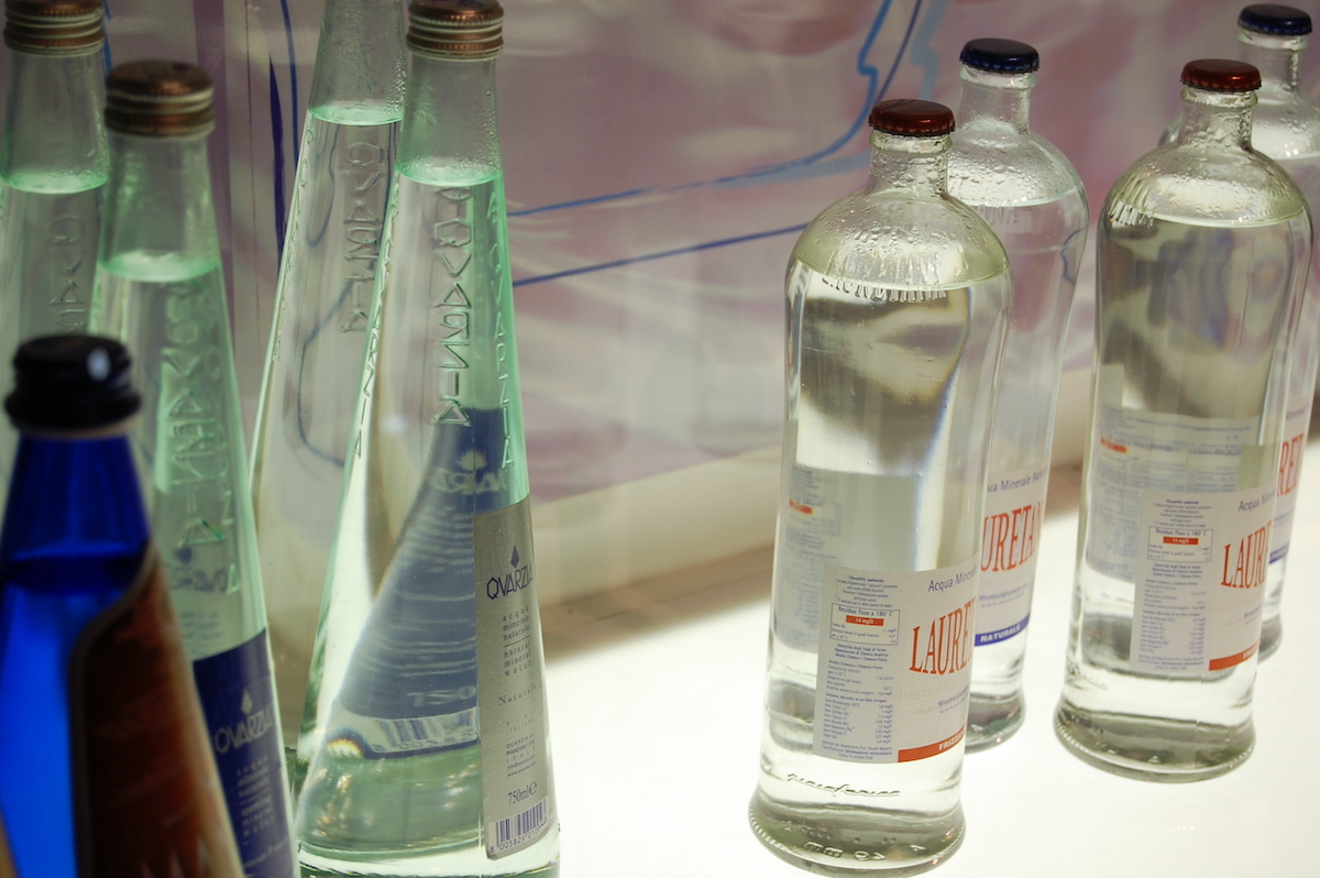 Several clear glass bottles of water