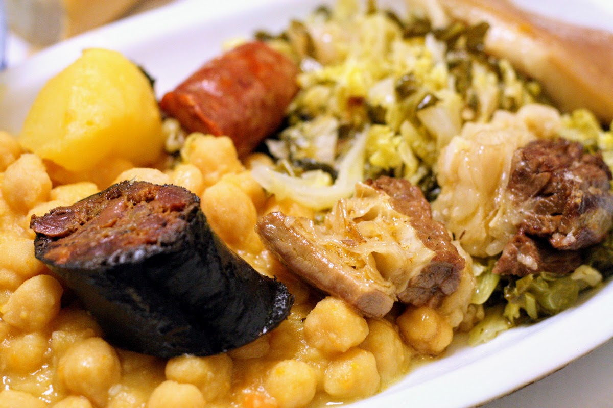 Plate of cocido madrileño: blood sausage, chickpeas, cabbage, pork, potatoes