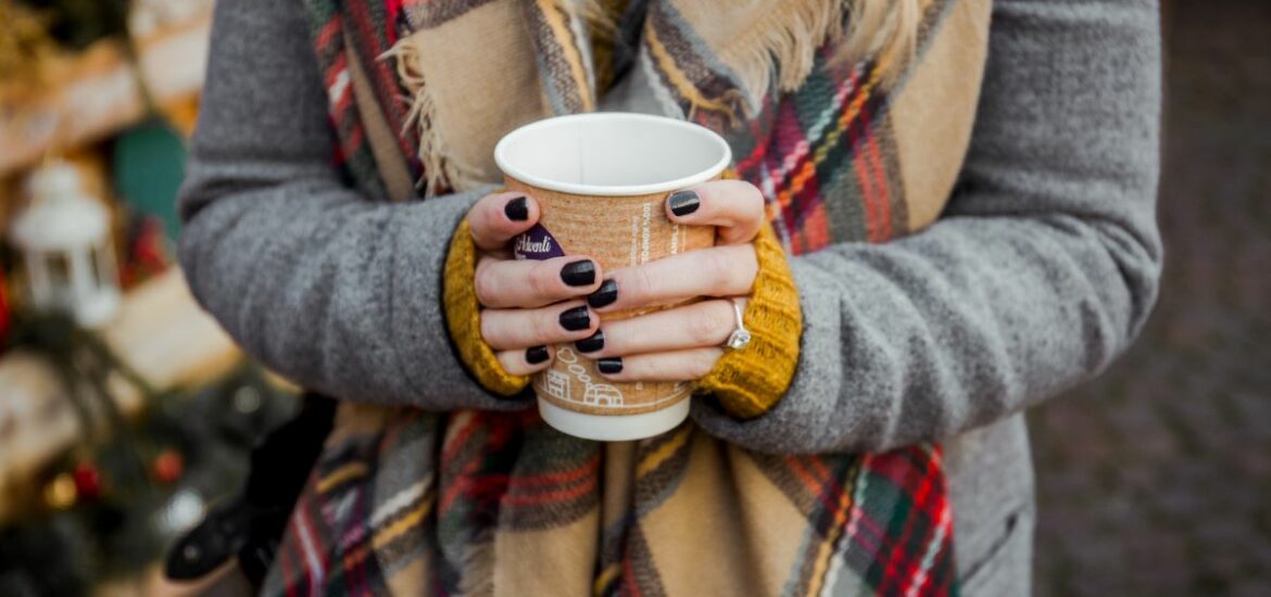 woman holding mulled wine.