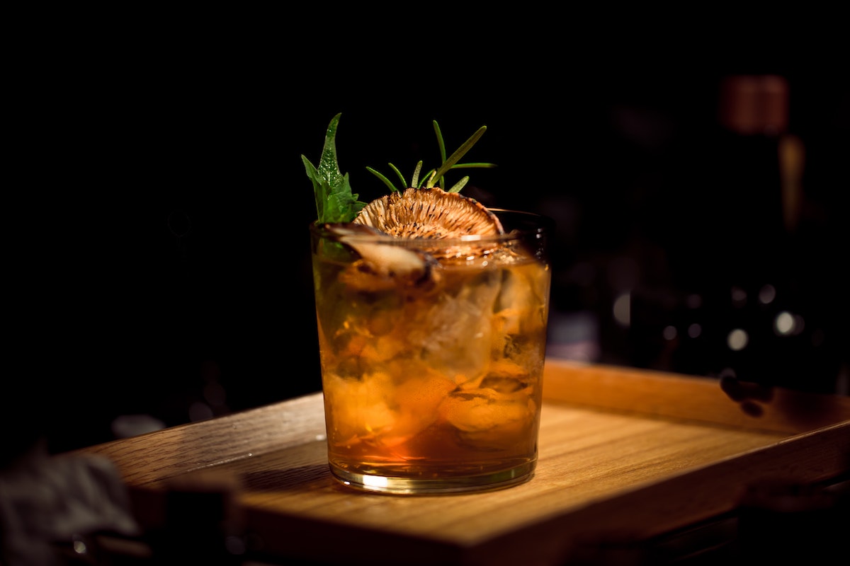 Brown cocktail in a rocks glass against a dark background