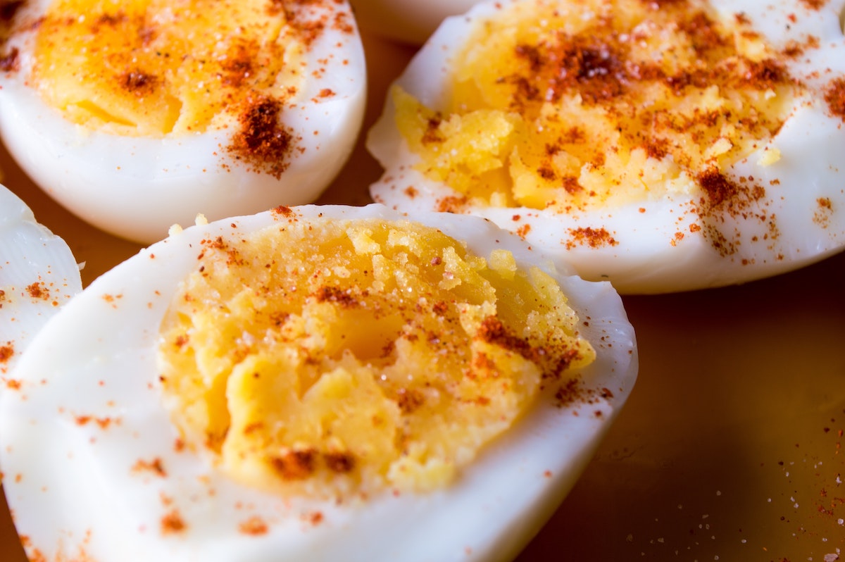 Close up of three deviled eggs sprinkled with paprika