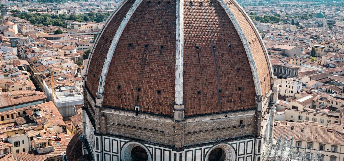 Close up of a red cathedral dome with the city of Florence, Italy in the background