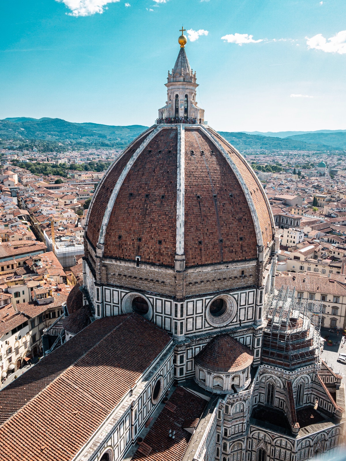 Close up of a red cathedral dome with the city of Florence, Italy in the background