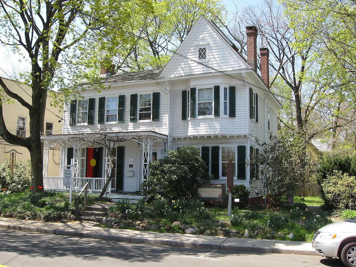 White two-story house on a suburban street