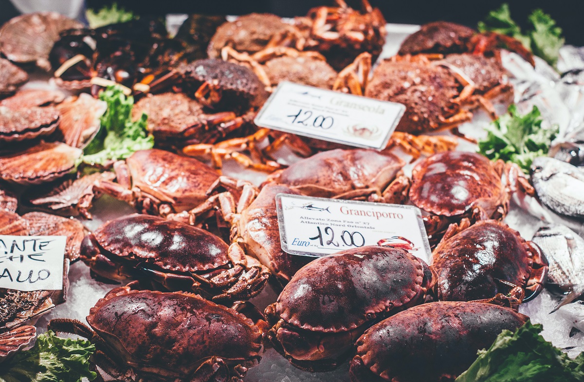 Fish at a market in venice with crabs and lobsters on ice