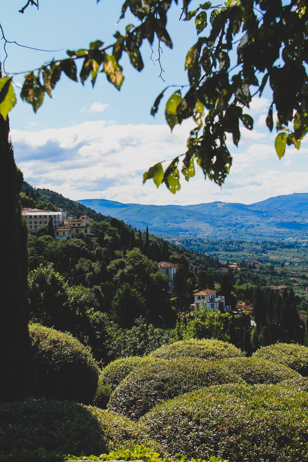 Green hilly area with some small buildings in the distance