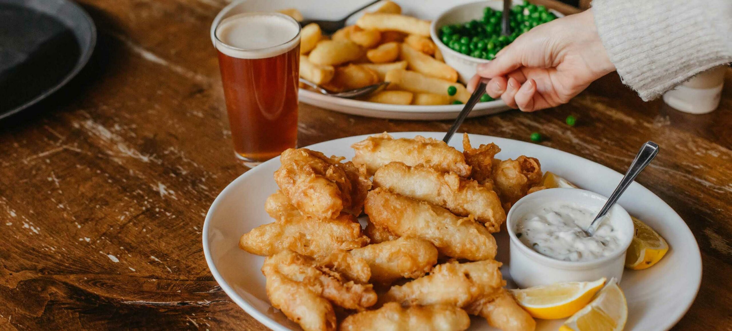Plate of fish and chips with beer glass