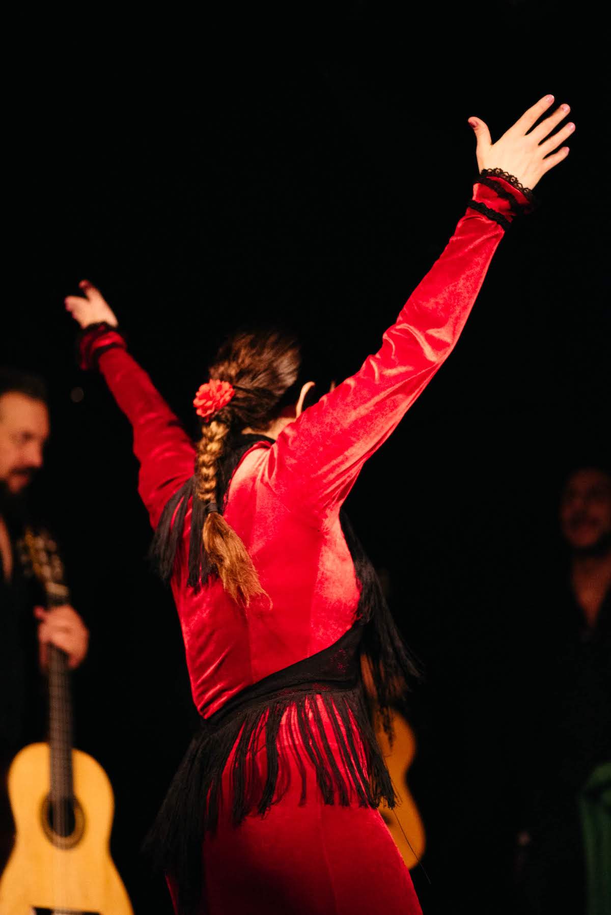 Woman wearing a red dress dancing flamenco.