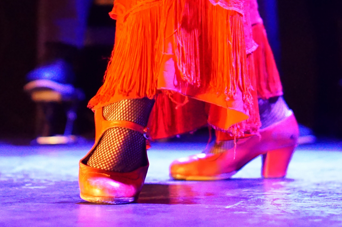 Female flamenco dancer's feet clad in red dancing shoes.
