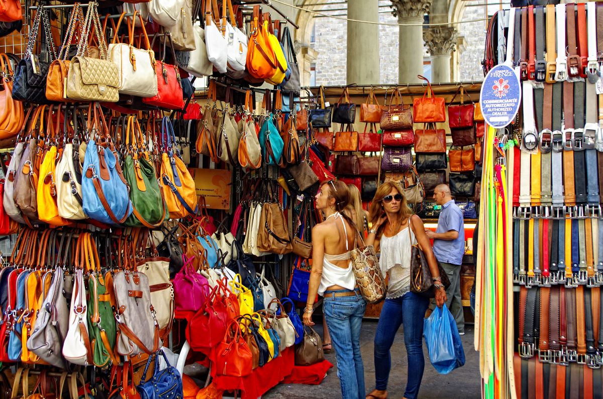 2 women shopping for leather goods in leather market in Florence 