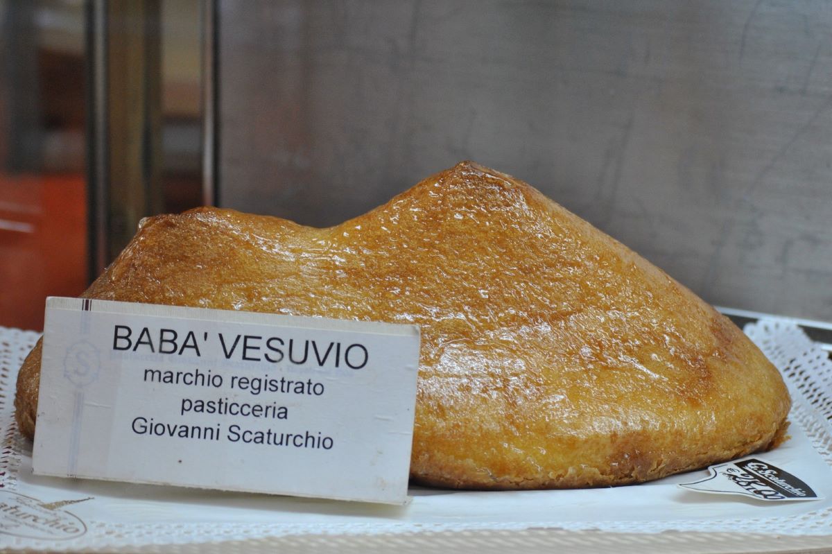 large pastry behind small white sign