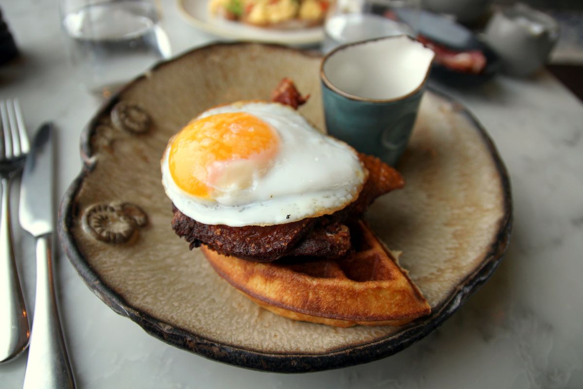 fried egg on duck and waffles