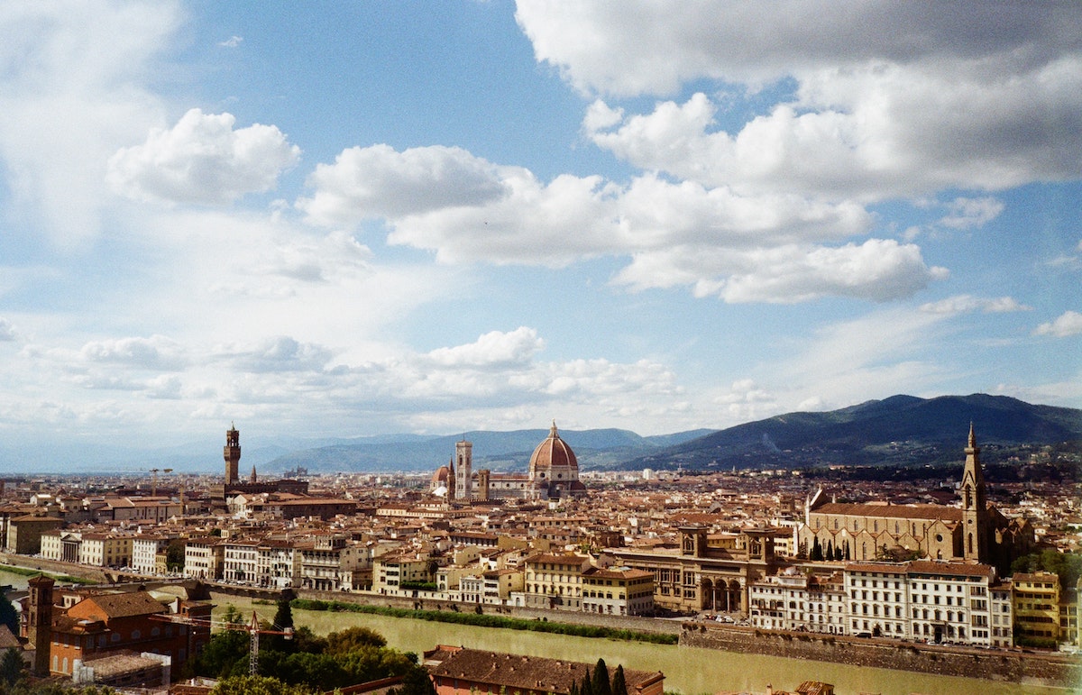 View of Florence, Italy, taken from across the river on a partly cloudy summer day
