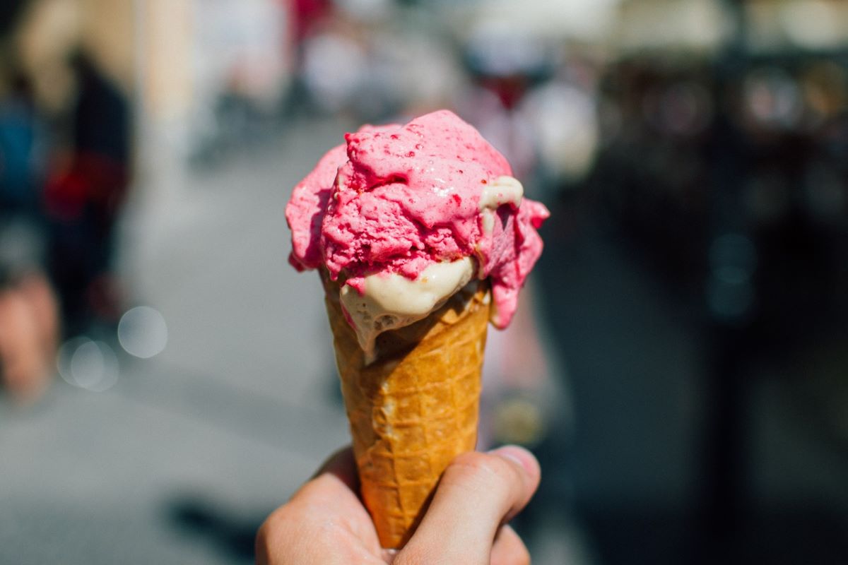 cone with pink ice cream with urban background